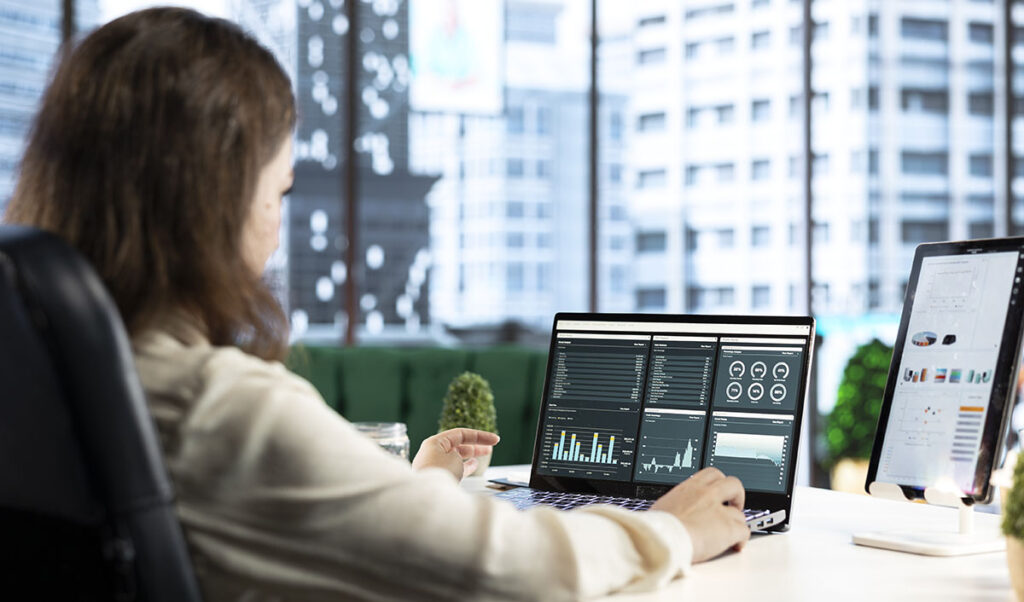 Affärsanalytiker analyserar data och trender på laptop med dashboard – illustrerar hur ledare använder AI-insikter från Microsoft Work Trend Index 2025 för strategiska beslut
